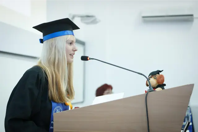 una donna che legge il suo discorso di laurea ad alta voce
